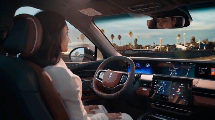 A person is shown driving hands-free on the highway with available Lincoln BlueCruise technology. | Klaben Lincoln in Kent OH