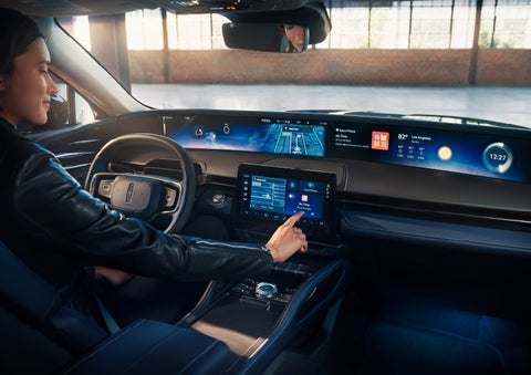 The driver of a 2024 Lincoln Nautilus® SUV interacts with the center touchscreen. | Klaben Lincoln in Kent OH